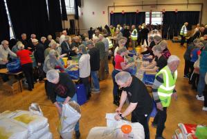 "Many hands make light work". Every one is busy with the packing. 